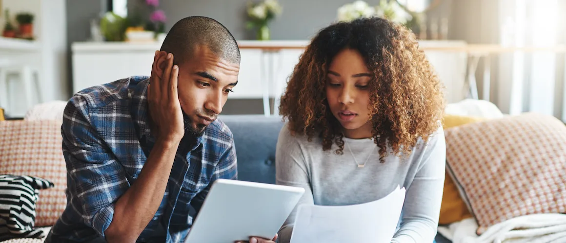 Stressed, worried and anxious couple doing finances, budget and internet banking.